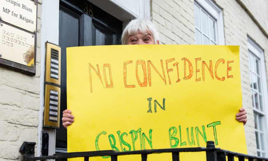 A protester outside the office of Crispin Blunt MP in Reigate, Surrey.