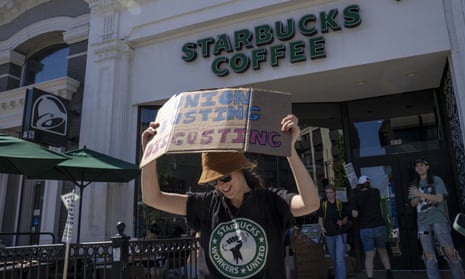Unionized workers strike for unfair labor practices outside a Starbucks location in the Brookline neighborhood of Boston, Massachusetts, US, in July 2022.