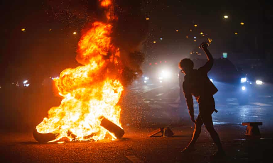 A protester burns tires and wood during a demonstration in bangkok.