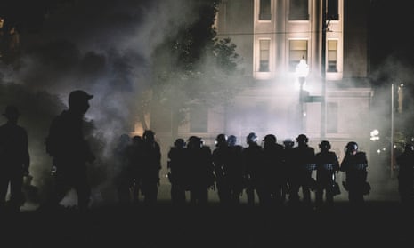 Police move into protester lines through clouds of teargas in Kenosha, Wisconsin, on 25 August 2020.