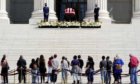 People pay respects as Justice Ruth Bader Ginsburg lies in repose under the Portico at the top of the front steps of the Supreme Court in Washington DC.