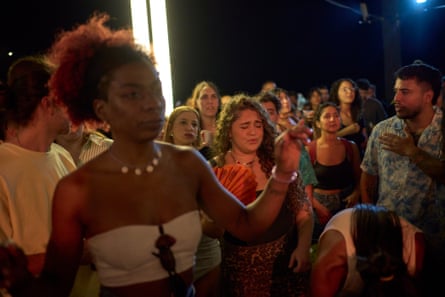 Crowds of people gather in the streets.