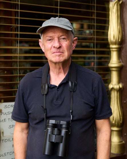 Nick Addey looks at the camera and has a pair of binoculars around his neck.