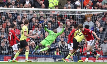Manchester United’s André Onana makes a save to deny Burnley.