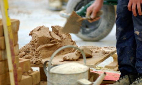 A bricklayer mixing mortar