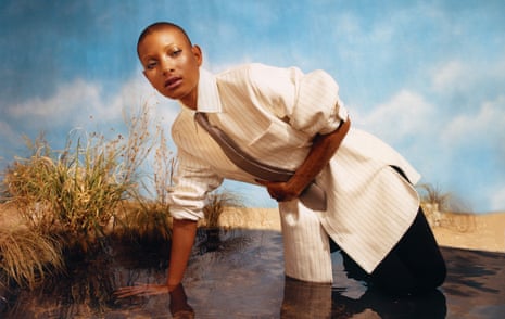 Will Smith in shirt and tie, leaning over in a pond