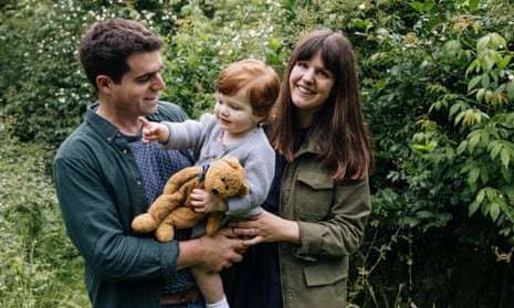 Matt and Clemmie Collins with their son in the garden at Benton End in Suffolk.