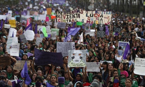 Protestors carry signs as they march on International Women’s Day in Mexico City, Friday, 8 March 2019. 