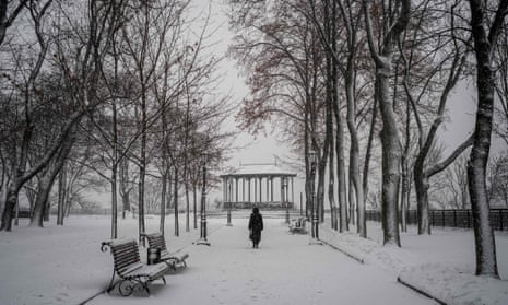 A woman walks in a snow-covered park after a fresh snowfall in the centre of the Ukrainian capital Kyiv on Thursday.