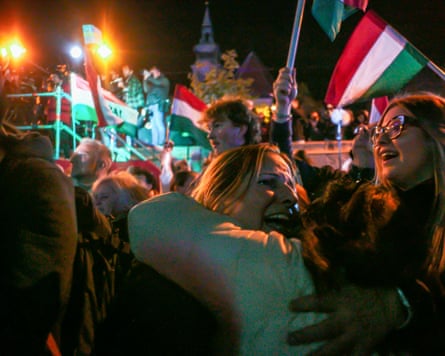 Hungarians with flags hug each other