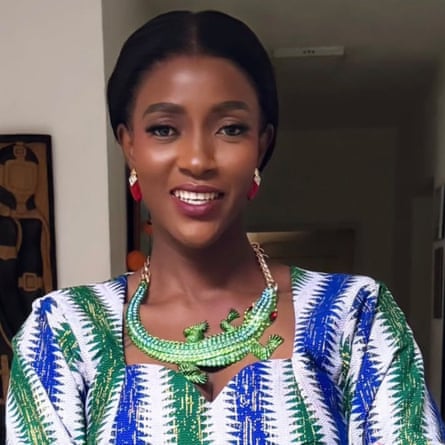 A young African woman in a blue and green dress – the colours of Sierra Leone’s flag