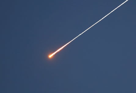A missile burns across the sky