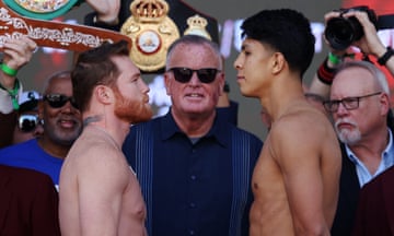 Canelo Álvarez, left, and Jaime Munguía face off at Friday’s ceremonial weigh-in ahead of their super middleweight title fight in Las Vegas.