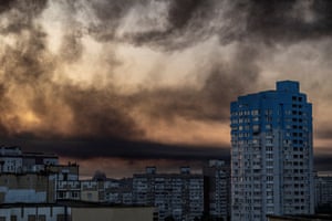 Smoke rises over an urban landscape