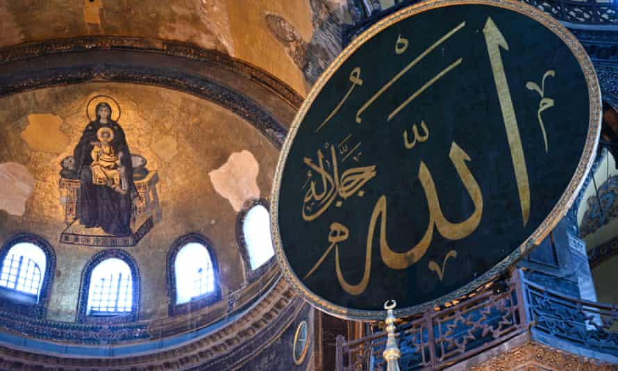 Virgin Mary and child fresco (L) and a calligraphic roundel bearing the name of Allah and other Muslim prophets hanging on the dome of the Hagia Sophia museum,Istanbul.