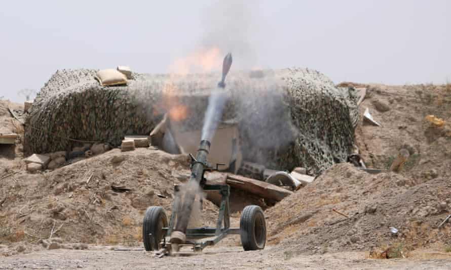 Syrian Democratic Forces fighters fire a mortar shell towards positions held by Isis in Raqqa.