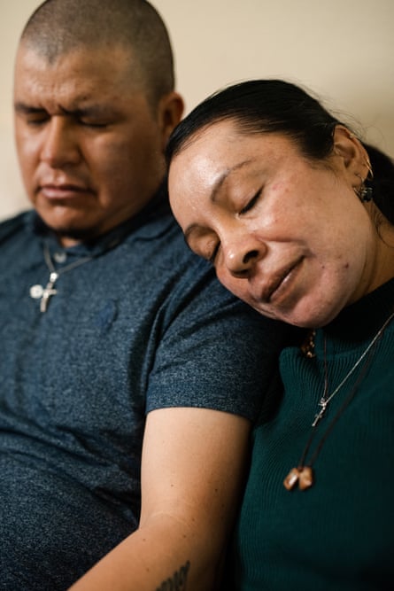 woman and man sitting together with eyes closed, the woman resting her head on the man’s shoulder
