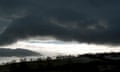 Dark clouds over a rural landscape
