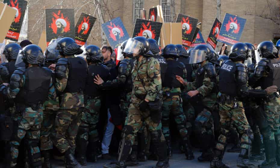 Iranian anti-riot police scuffle with protesters during a demonstration near the Saudi embassy in Tehran.