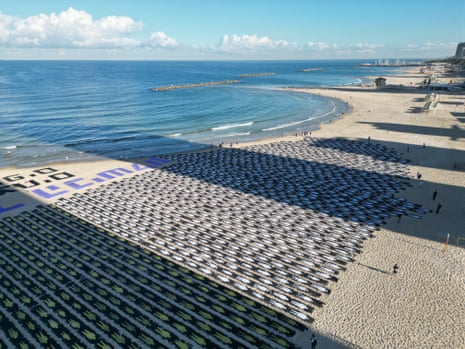 Aerial view of human figures displayed at a Tel Aviv beach as part of a protest.