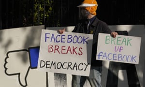 A demonstrator protests outside of Facebook CEO Mark Zuckerberg’s home.