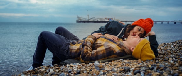 Man and woman lying on a stony beach