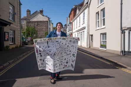 Ethan Pennell holding a Dartmoor folklore map.