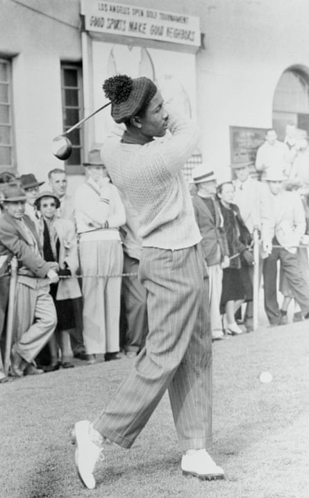 Ted Rhodes swings a golf club.