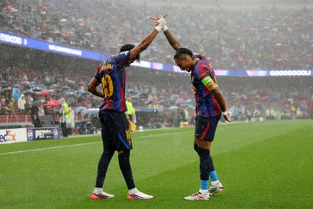 Raphinha celebrates with Lamine Yamal