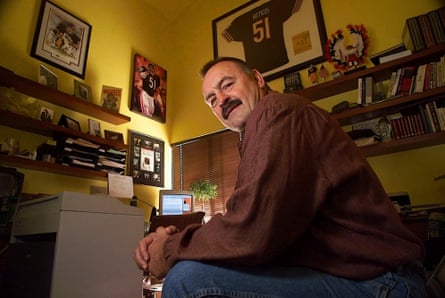 Former Chicago Bears linebacker Dick Butkus is surrounded by football memorabilia at his home in Malibu, California, in January 2000.