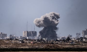 Smoke rises as the Israeli army's attacks the north of Gaza, as seen from the Kfar Aza region of Israel on 12 May.