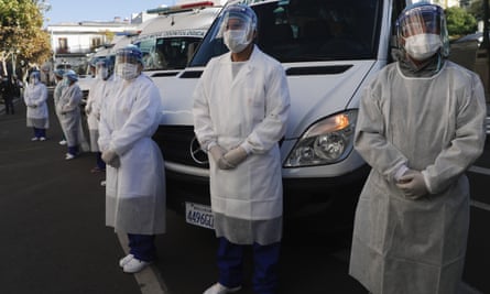 Healthcare workers stand dressed in full protection gear during an inspection in La Paz, Bolivia, on 28 May before departing to the Amazonian region of Beni in a caravan of medical teams to help in the fight against the new coronavirus pandemic.