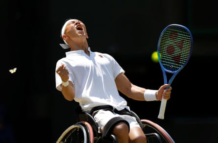A butterfly flies past as Tokito Oda of Japan celebrates winning the second set in his victory over Alfie Hewett at Wimbledon.