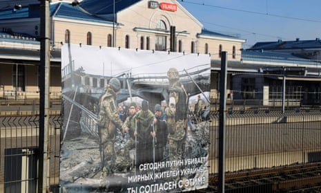 A photograph taken by Ukrainian photographer, Maxim Dondiuk, on display along with  other photographs of Russia's war in Ukraine at the railway station in Vilnius, Lithuania, where transit trains from Moscow to Kaliningrad pass through.