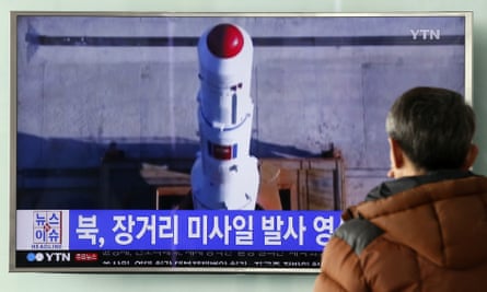 A man at Seoul’s central train station watches a TV news bulletin about North Korea’s long-range missile test.