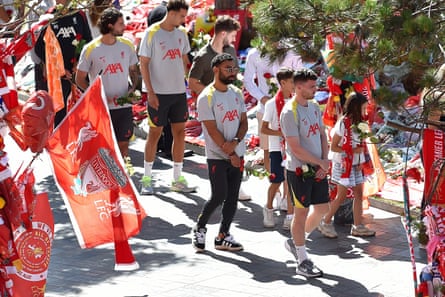 Liverpool players including Mohamed Salah view the tributes to Diogo Jota outside the Main Stand at Anfield.