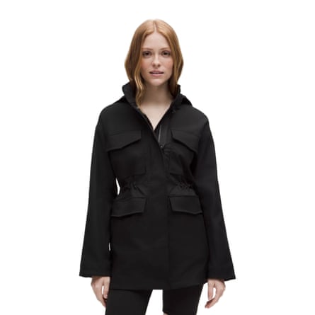 A woman with ginger hair wears a black Lululemon DryField Utility Jacket