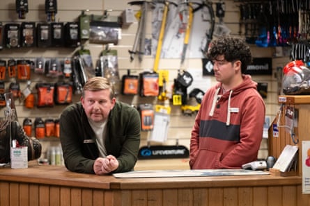 Two man stand behind the counter in a hardwear shop.