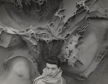 A woman looking at a camera.