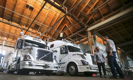 Employees stand next to self-driving, big-rig trucks at the Otto headquarters in San Francisco. Uber bought Otto for an estimated $680m.