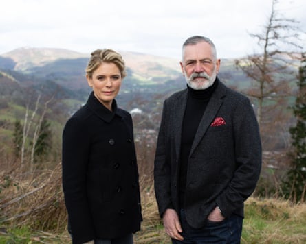 A publicity shot of Emilia Fox and Prof David Wilson posed standing side by side on a hillside