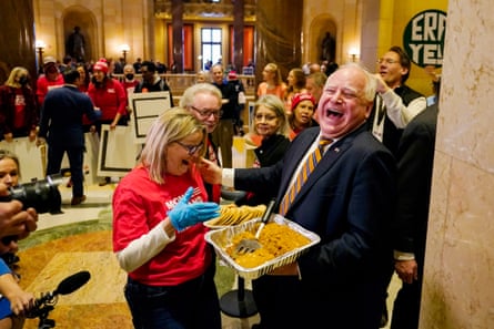 a man laughs while handing out pumpkin bars