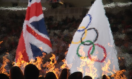 The union jack and the Olympic flag fly above the flames in the stadium this morning