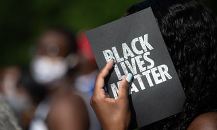 A demonstrator holds a card that reads ‘Black lives matter’ in Georgia