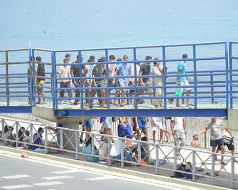 Migrants walk towards the border with Morocco to leave Spain, in Ceuta, Spain.