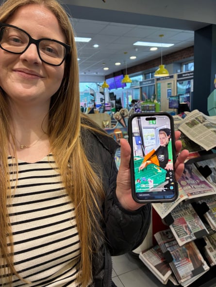 Van Bladel holding up a mobile phone.