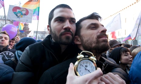 Protesters in Milan hold an alarm clock