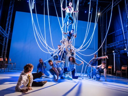 Actors on stage against a blue background in A Monster Calls at the Old Vic, London.