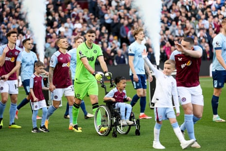6 April 2024 Emi Martínez pushes out one of the many young mascots before Aston Villa versus Brentford at Villa Park. The match ended 3-3.