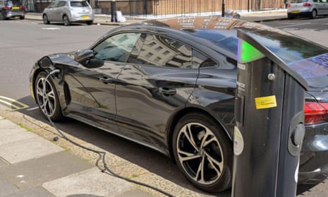 An electric car plugged into a rapid battery recharging point on a street in central London.